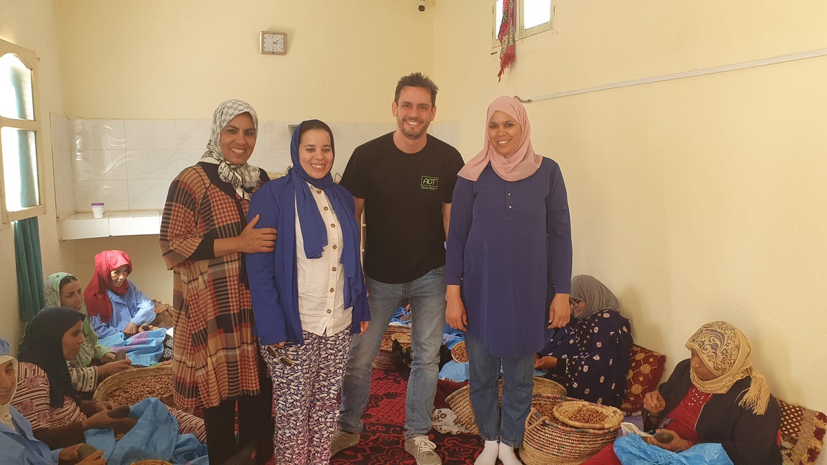 Visit to a women’s cooperative in Morocco, with women processing argan nuts in the background